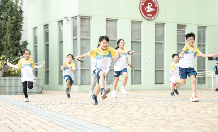 Students happily skipping rope at school